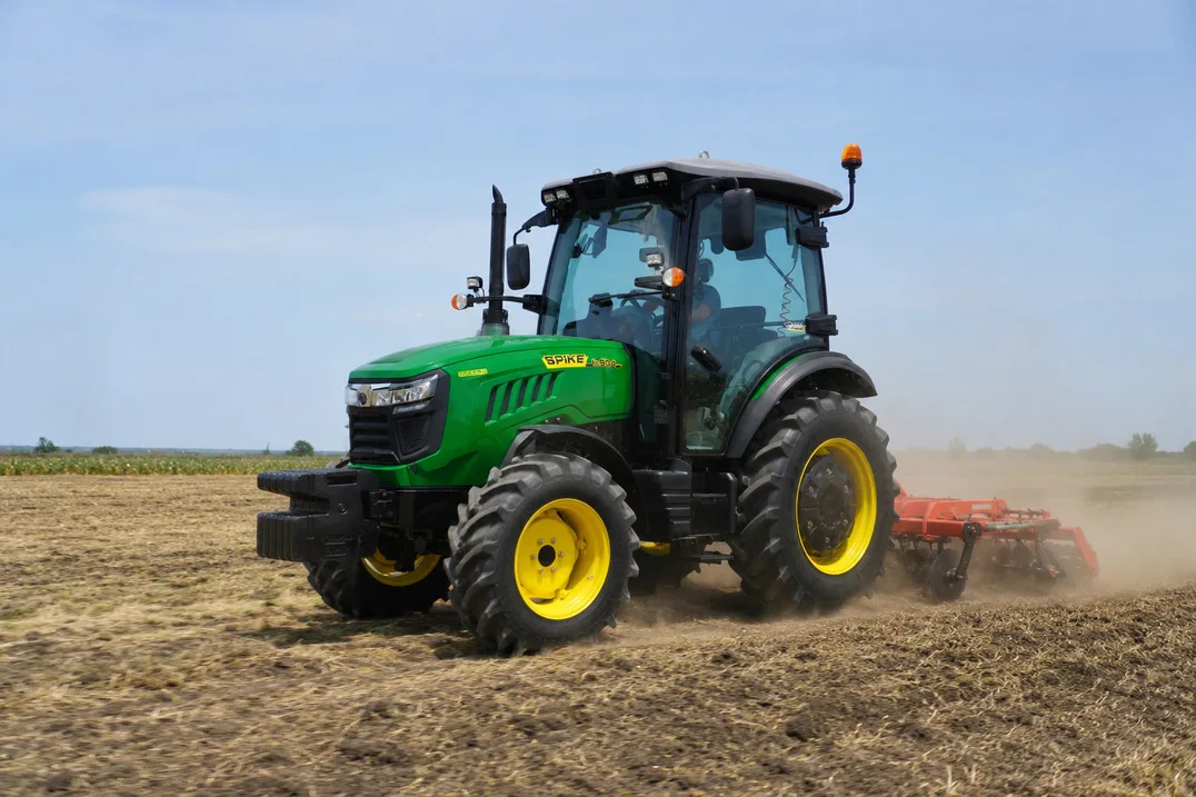 SPIKE TK 904 90 hp tractor working in a field with a cultivator